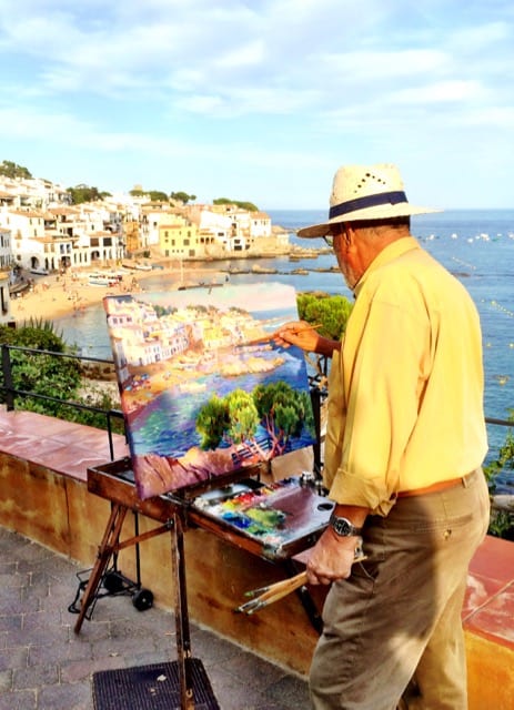 An artist painting the scenery of Calella de Palafrugell.