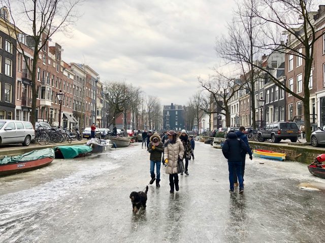 people-on-frozen-canal-amsterdam-photo