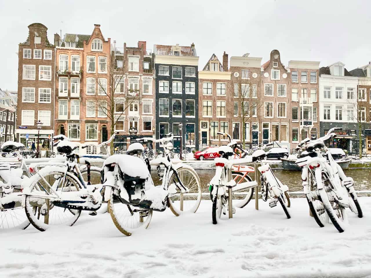 Snow and frozen canals in Amsterdam Winter 2021 Velvet Escape