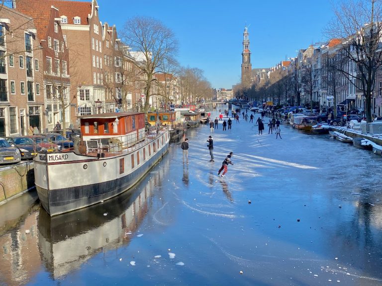 Snow and frozen canals in Amsterdam Winter 2021 Velvet Escape